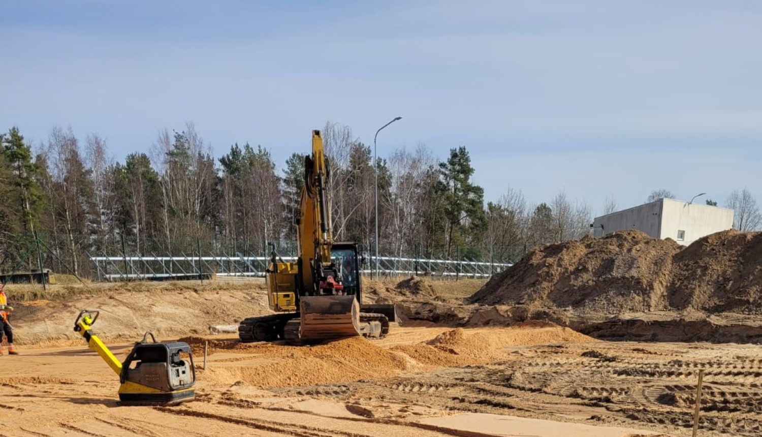 notiek būvdarbi atkritumu laukuma izbīvei, traktors veic darbus
